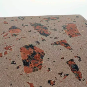 Concrete terrazzo finish sample with natural stone aggregates. Its mocha colour concrete with real granite and marble aggregates, using big chunky and smaller clippings.