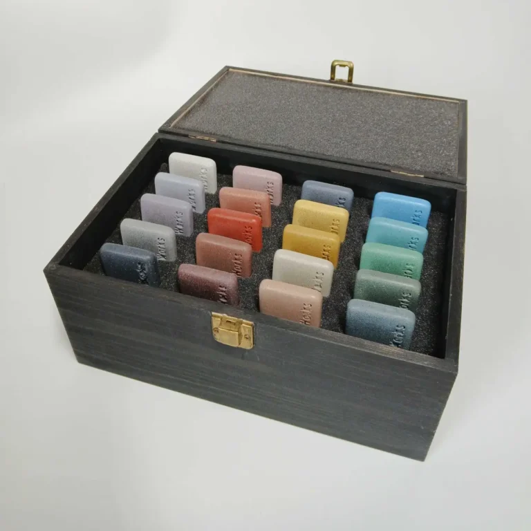 Nature inspired, custom concrete colours sample box. open box view, showing 20 concrete colour samples -grey tones, earth tones, sand and sun shades, aqua tones, forest tones.
