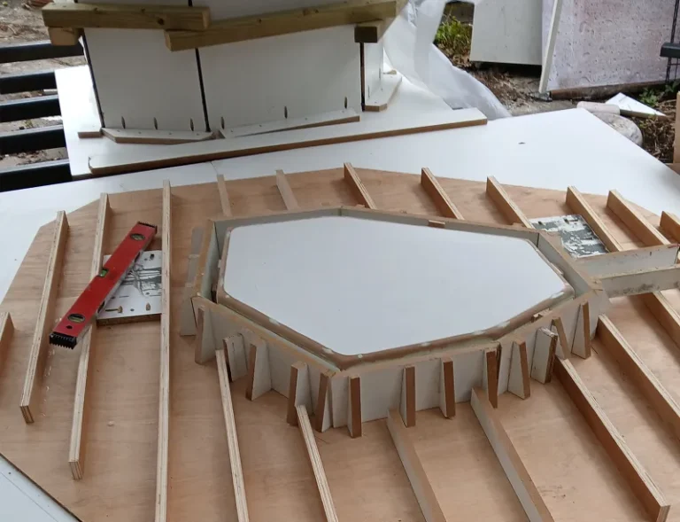 Precision formwork and mould making for an abstract angled concrete bar table at Gumi Works London studio.