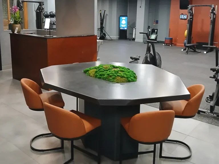 Finished bespoke designer geometric concrete bar table with an integrated preserved moss planter and abstract angular pedestal base.