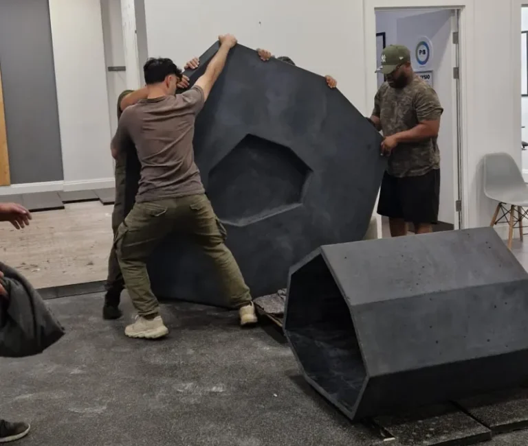 Professional delivery and on-site installation of a large architectural concrete bar table for a UK commercial interior.