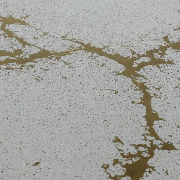 Metal-infused concrete surface featuring hand-applied brass veining for high-end furnitures in luxury interiors.