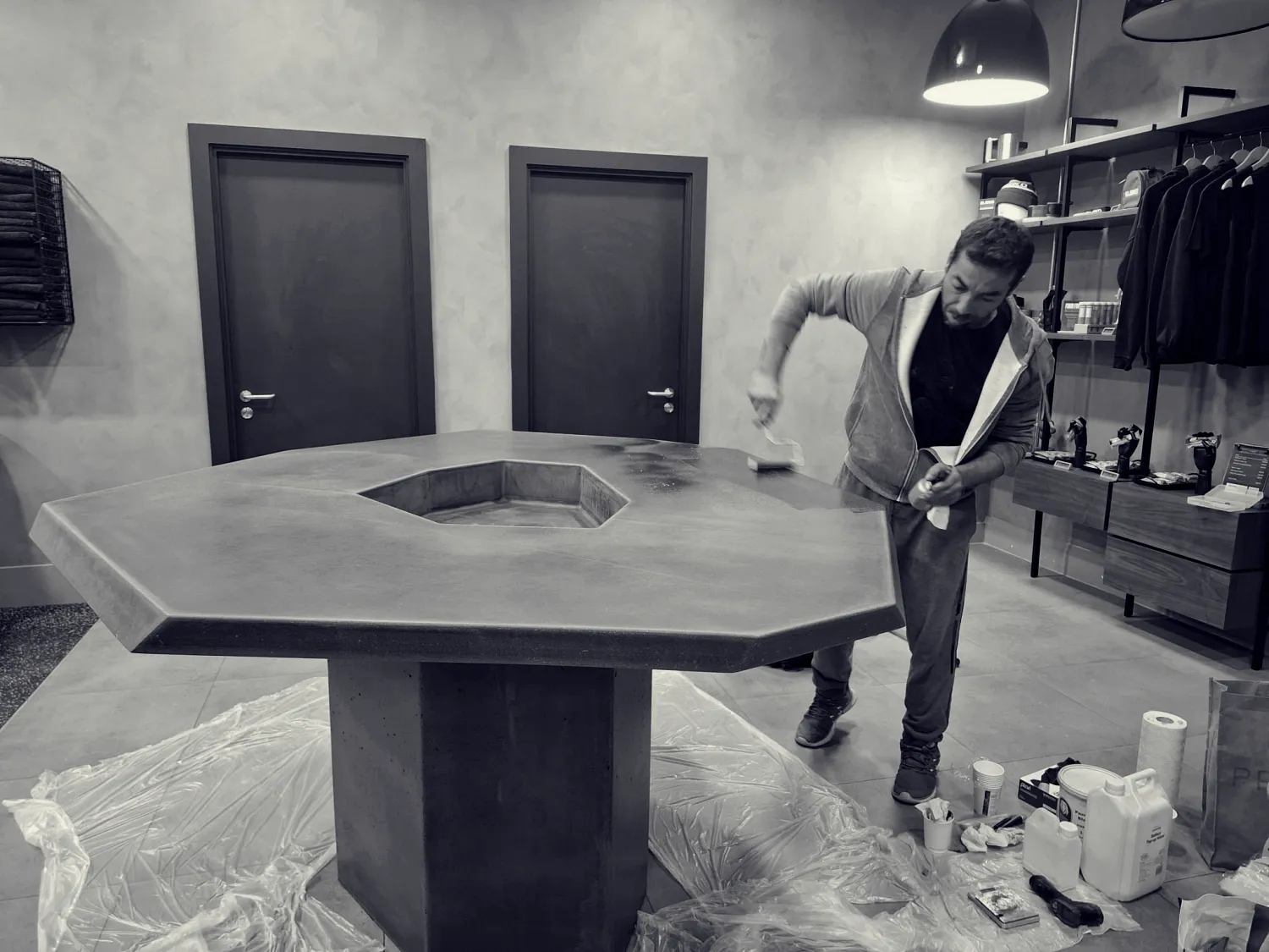 Custom made angular polished concrete bar table with integrated planter in-situ sealing process in London.