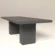 Modern brutalist style concrete table. Monolithic double pedestal base, shown in dark grey colour -handmade in London.