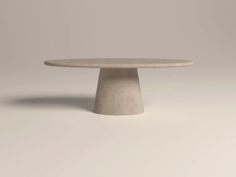 Oval dining table with pedestal base. Side view of table, made with gfrc concrete, in sand colour. Has a modern minimalist look to suit contemporary interiors -handmade in London studio.