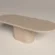 Handmade concrete dining table with pill-shape tabletop and pedestal base, shown at cross-angle view. Surface finished in clay colour polished concrete made in London for UK interiors.