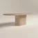 Pill-shaped concrete table with matching pill shape pedestal base, finished in clay colour polished concrete. A lower-back shot of the table in London studio workshop.