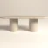 pill-shape-concrete-dining-table-double-pedestal-soft-modern-dune-londoon Oval, pill-shape concrete dining table with double circular pedestal base. Bespoke design from London Studio, shown in sand dune colour.