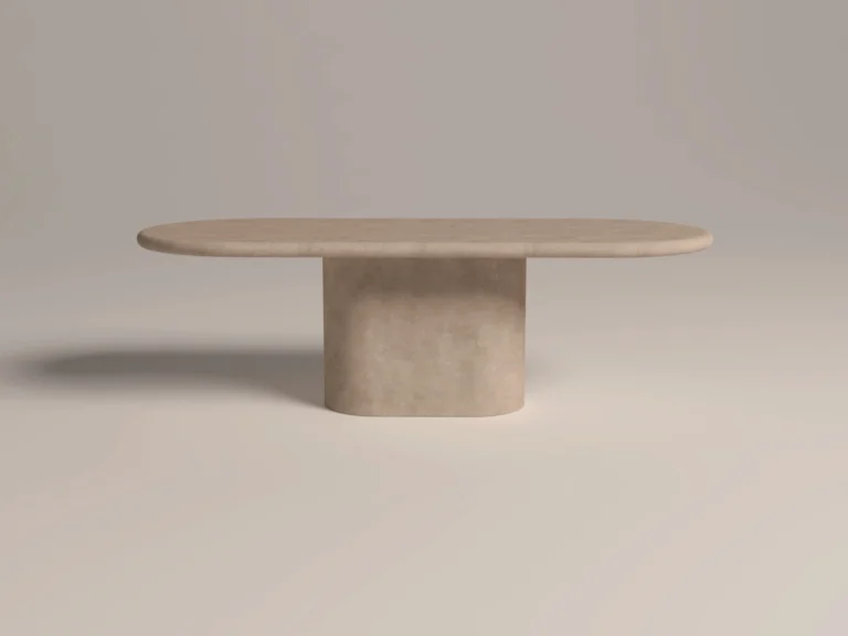 Pill-shaped, round and soft edge pedestal base dining table. racetrack shaped top has a matching pedestal base, finished in clay colour polished concrete. shown in soft light side view shot in London Studio UK.