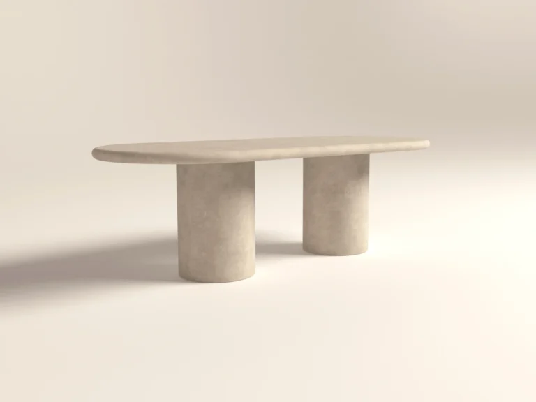 Pill shaped, oval racetrack dining table with double pedestal base. Made with gfrc concrete. Shown in lower back angle.