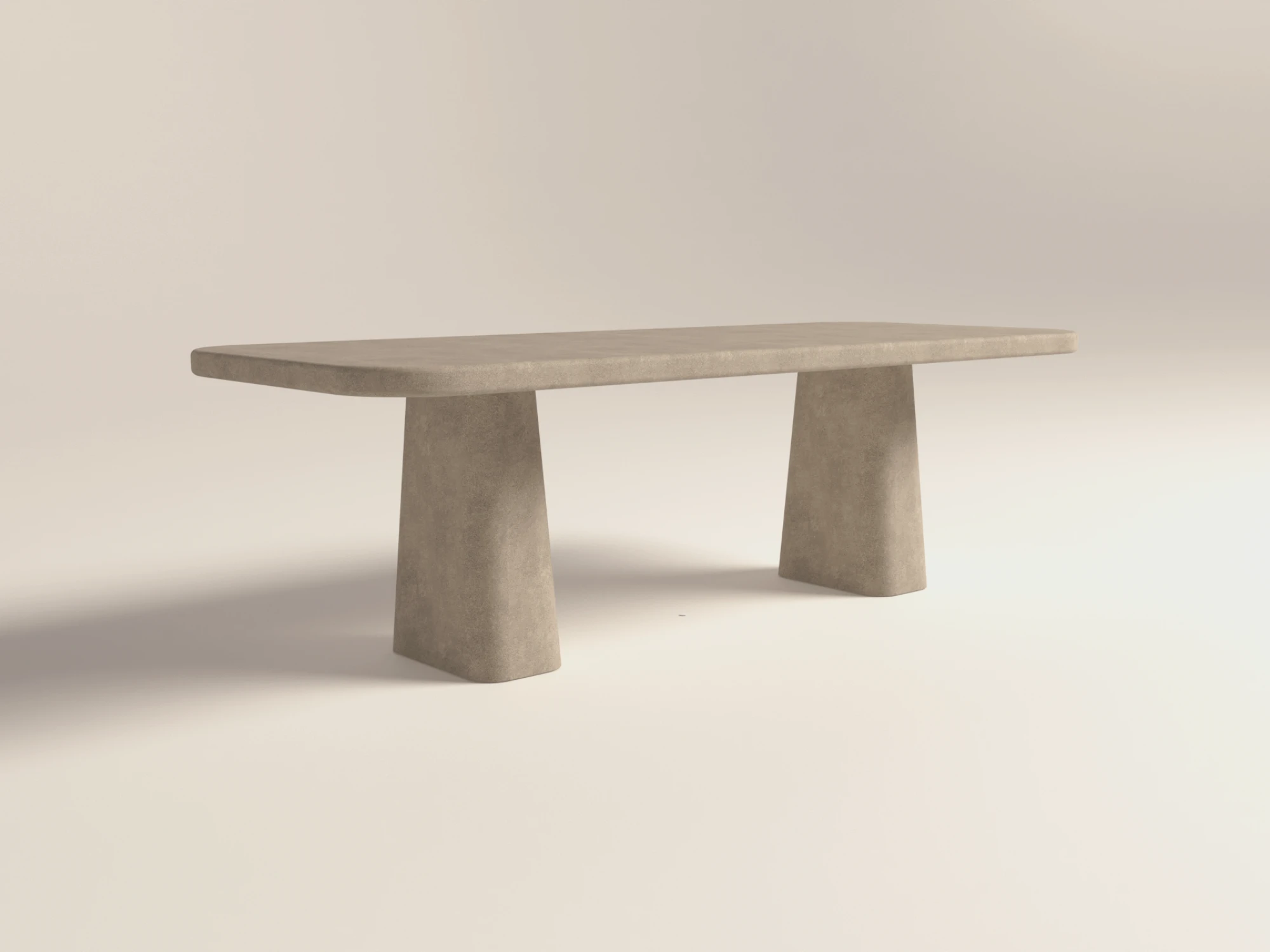 rectangular-concrete-dining-table-rounded-sculptural-pedestal-limestone-side-london-uk Rounded rectangular concrete dining table with sculptural double pedestal base. Lower-back view of table, finished in clay colour polished concrete - London UK.
