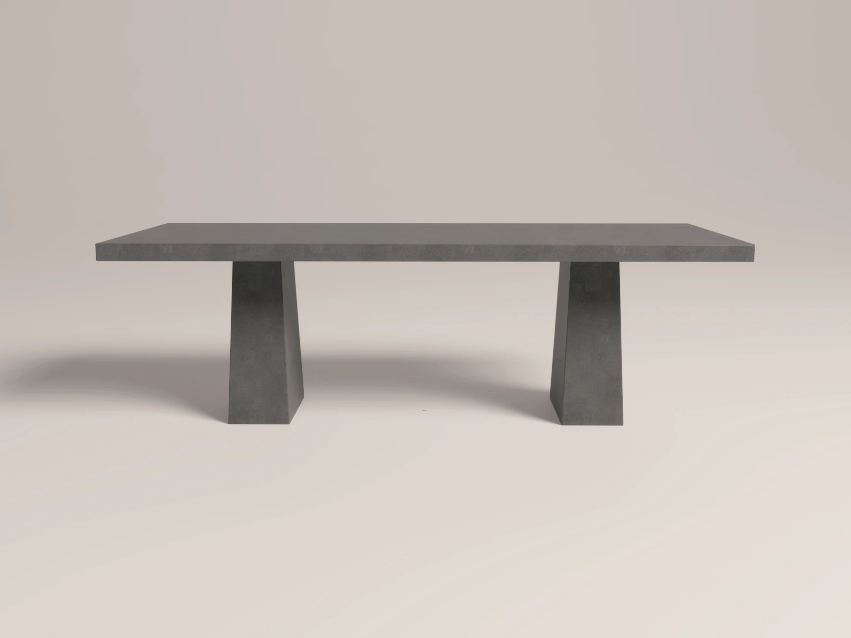 rectangular-dining-table-concrete-double-architectural-pedestal-side-london-uk Concrete dining table with architectural trapezoid double pedestal base. Side view of table, finished in anthracite colour polished concrete with modern minimalist design.