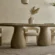 scultural-dining-table-oval-double-pedestal An interior perspective showcasing a bespoke oval Sculptural Pedestal Concrete Dining Table, acting as a standalone architectural statement piece within a soft-modern Japandi style UK interior.